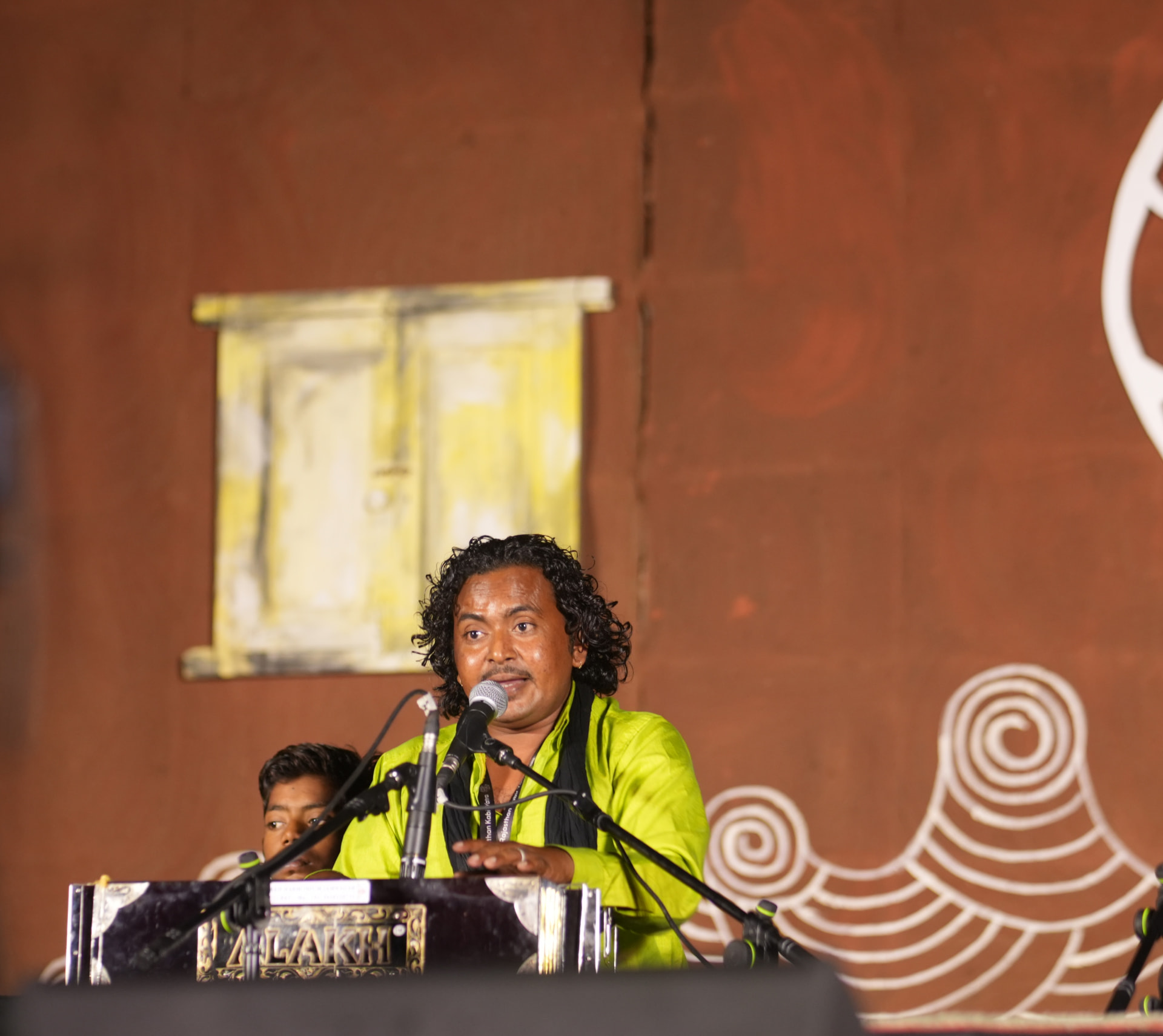Mir Rajak Ali singing at a night concert